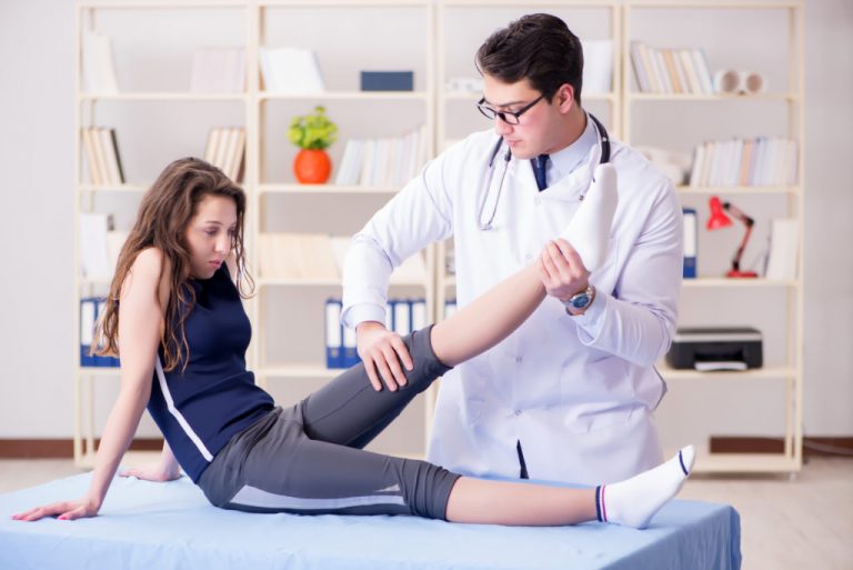 Man doctor taking care of sports injury