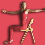 Woman,Practicing,Yoga,Therapy,,Performs,A,Lateral,Twist,While,Sitting